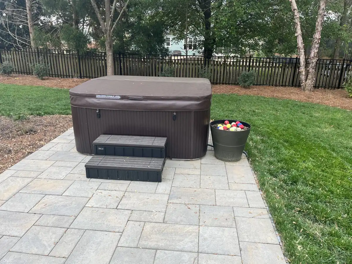 Backyard hot tub on a stone patio