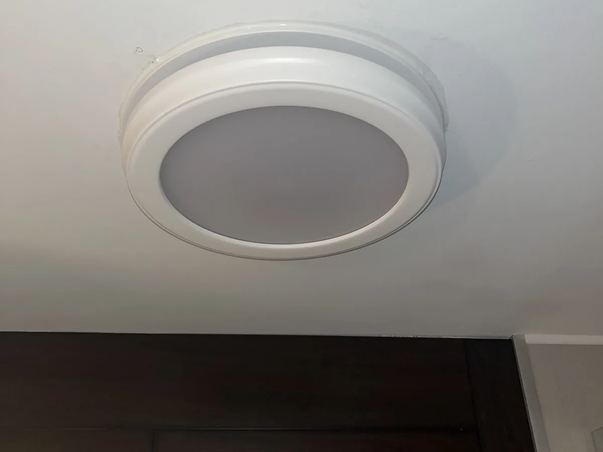 Round LED ceiling light installed above a doorway