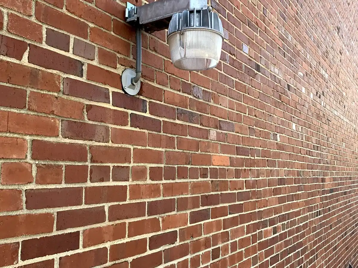 Outdoor security light mounted on a brick wall