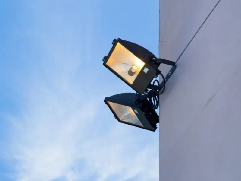 Dual floodlight security fixture on a home exterior at dusk