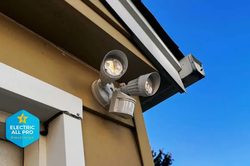 Motion-activated dual security light installed under a Raleigh roofline