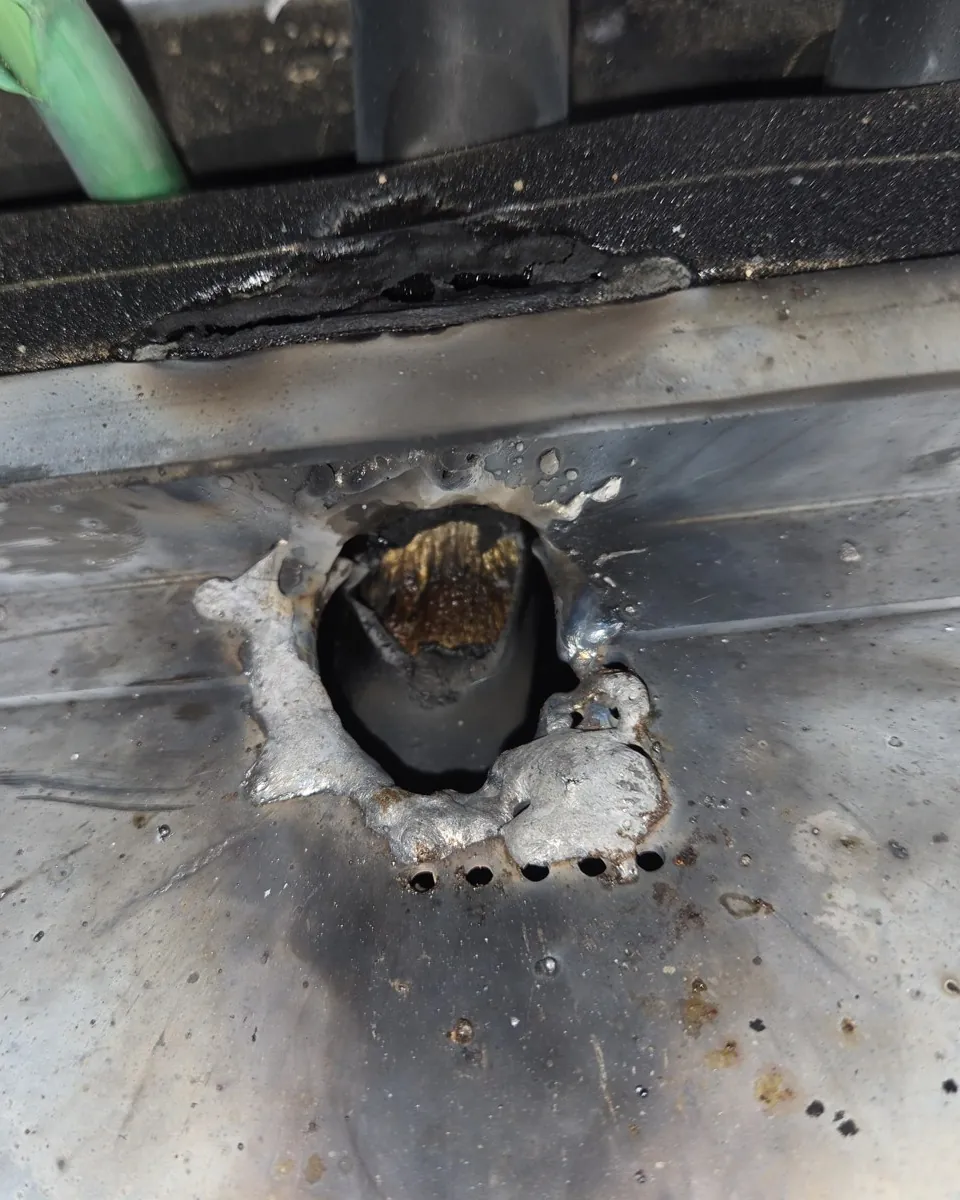 Panel cover melted through by an electrical arc, found on an emergency call