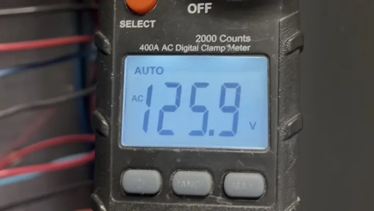 Clamp meter reading 125.9 volts while testing the repaired circuit
