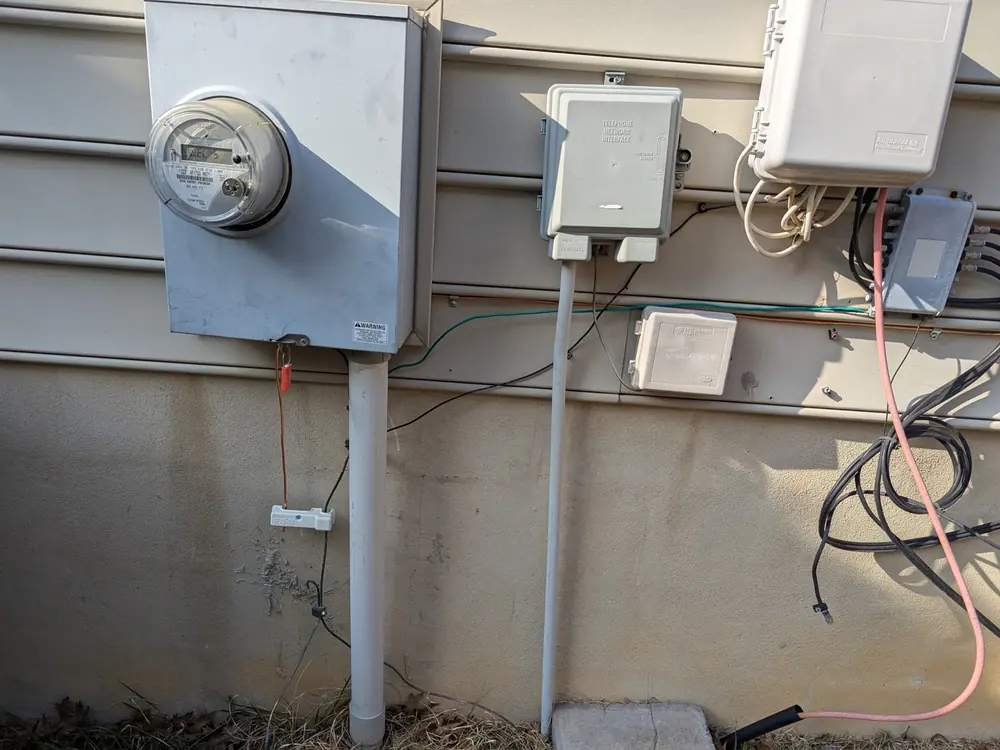 Utility meter and electrical boxes mounted on an exterior house wall in Boylan Heights, Raleigh
