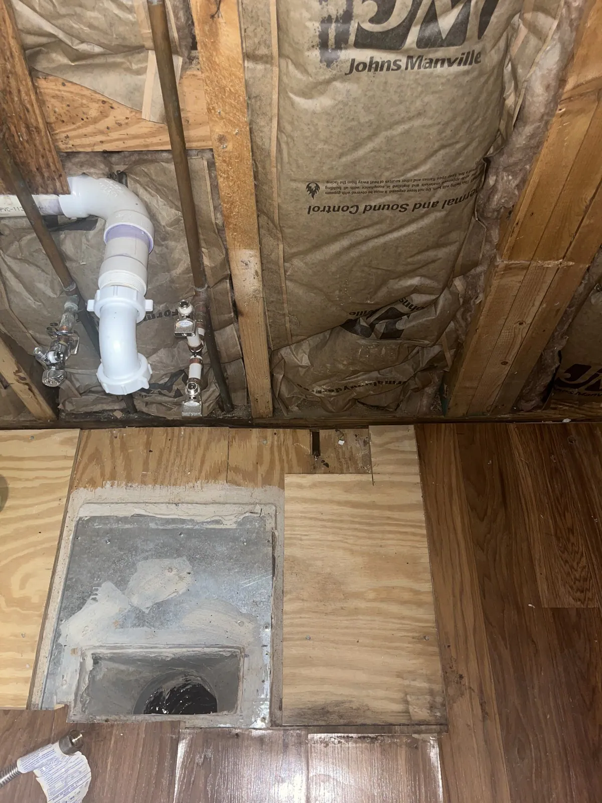 Opening cut into the floor revealing insulation and wooden beams in the attic or crawlspace below in Mordecai, Raleigh