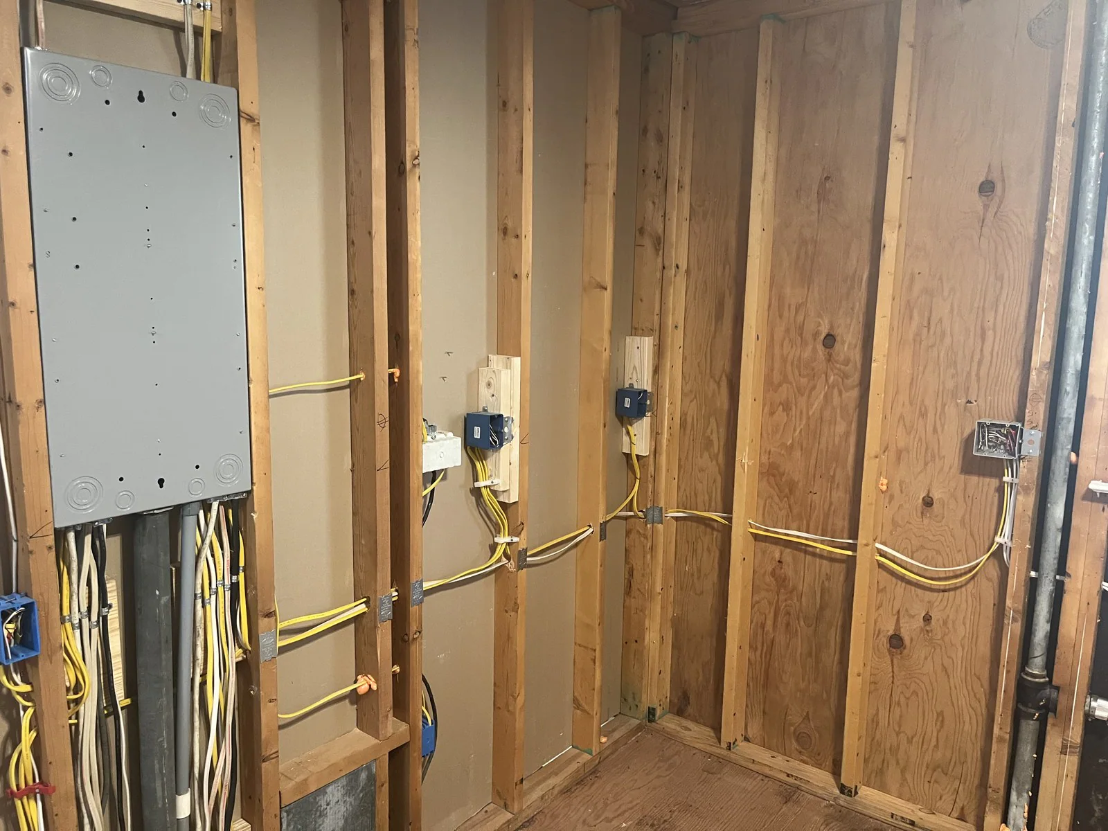 Electrical panel set within unfinished wooden wall framing with wiring running to it in Mordecai, Raleigh