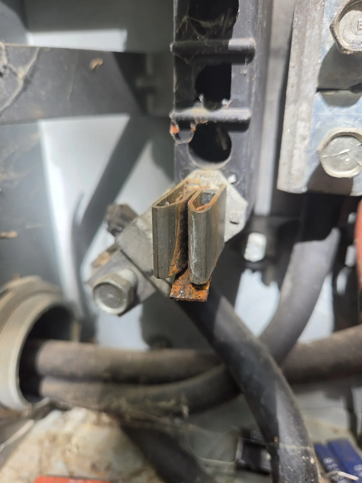 Close view of a rusted electrical connector on a panel, in Oakwood, Raleigh