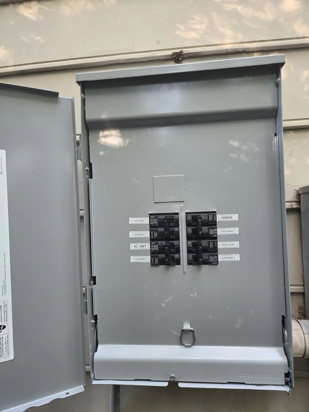An open electrical panel with labeled breakers and a main breaker, in Oakwood, Raleigh