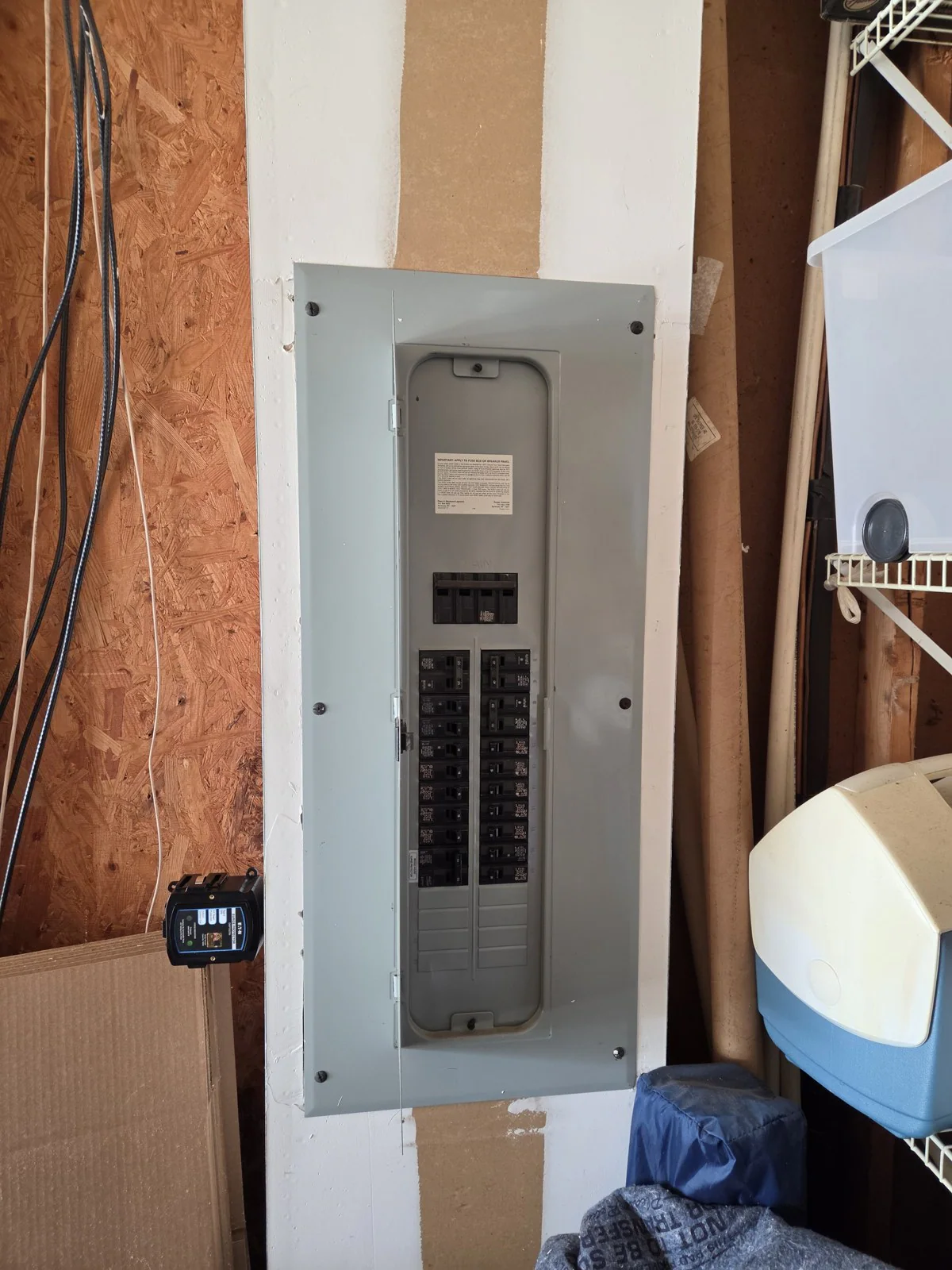 Electrical panel mounted on a wall with unfinished wood around it, in Wakefield, Raleigh