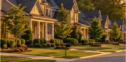 Homes along a quiet suburban street in late afternoon light
