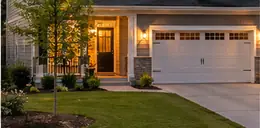 Newer two-story home with a garage and young trees