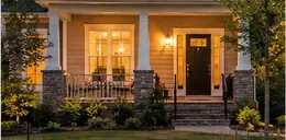 New subdivision home with a front porch at dusk