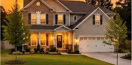 2000s two-story suburban home with a lawn