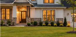 Newly built home with a fresh lawn at sunset