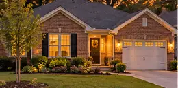 Newer single-story brick home with a tidy lawn