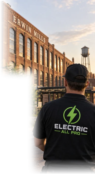 Erwin Mills brick building in West Durham, an Electric All Pro electrician in front