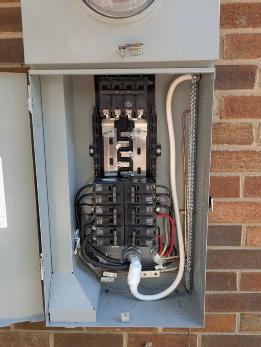 Close-up of the breaker bus, conductors, and neutral bar inside a Siemens 200-amp panel in Raleigh