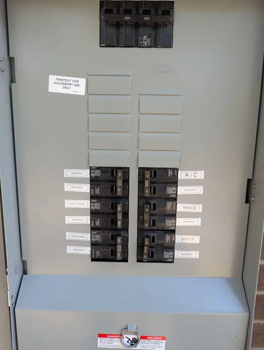 Labeled breakers and 200-amp main disconnect inside the completed Siemens meter-main panel in Raleigh, NC