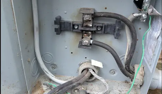 Existing meter base interior and service conductors exposed after electrical panel removal in Raleigh, NC