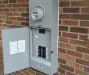 Completed 200 amp Siemens meter-main electrical panel installed on a brick home in Raleigh, NC
