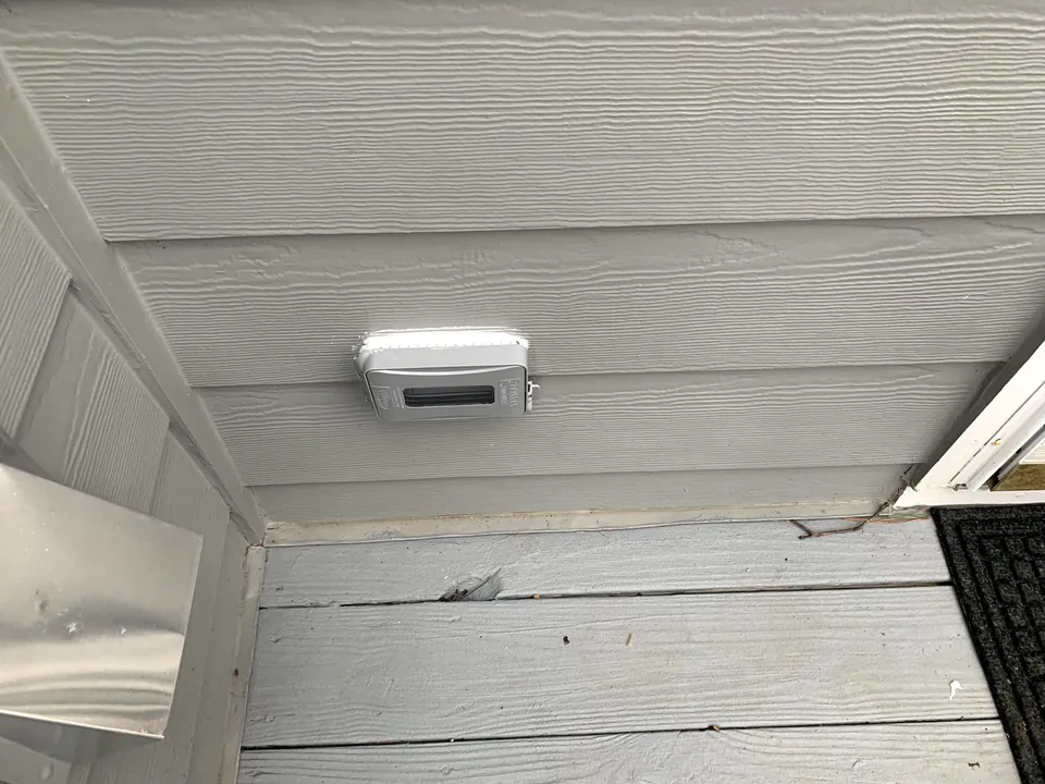 Outdoor outlet with a weatherproof in-use cover under a deck