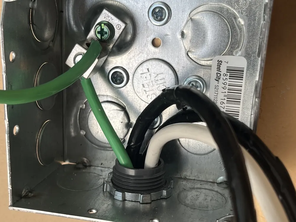 Metal electrical box with the wiring connected and grounded, before the outlet is installed