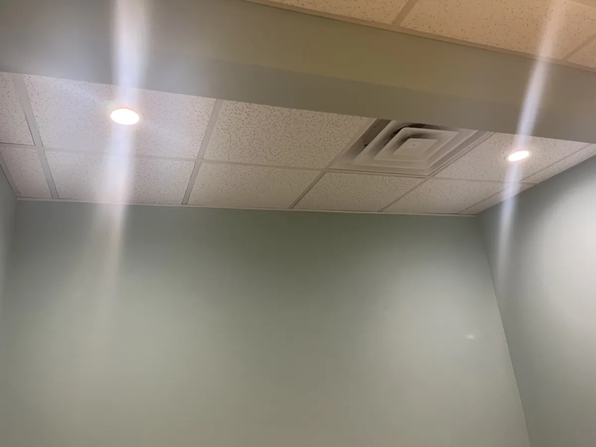 Row of new recessed LED lights glowing along a ceiling, installed by Electric All Pro in Raleigh, NC